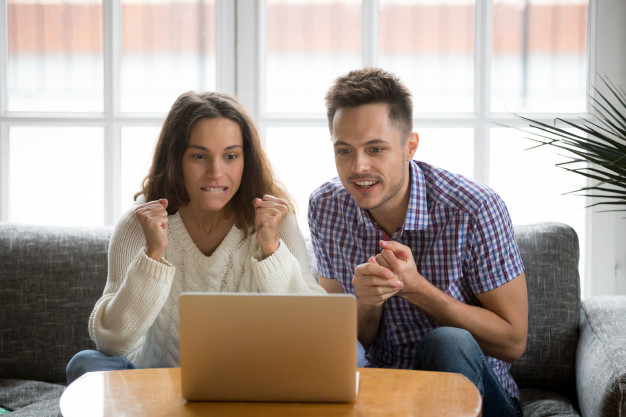 Couple watching game on laptop