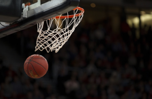 A photo of a basketball under the basketball hoop