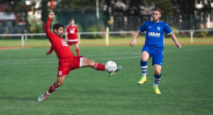 Two football players competing for the ball