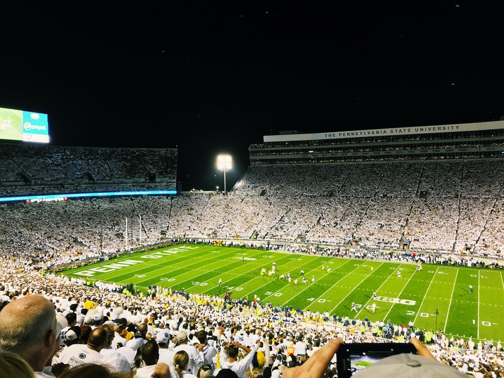 A picture of a group of people watching a football match in a stadium