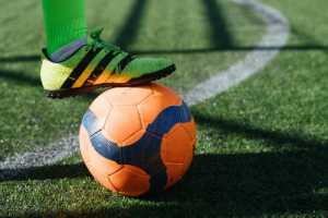 Man stopping the football ball with his feet
