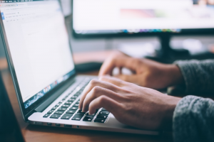 Man using a laptop for online sports betting