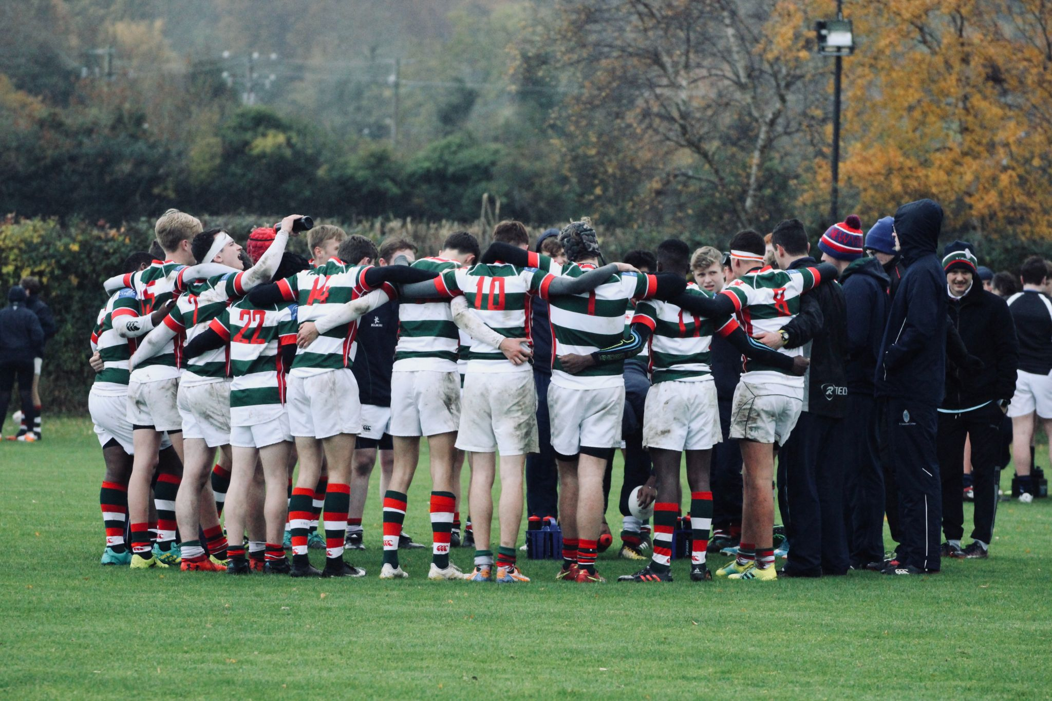 A group of rugby players in a hurdle