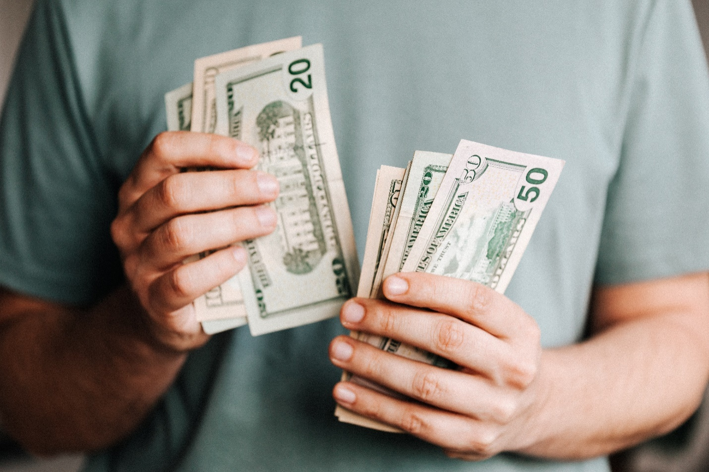 A man counting money after winning a bet.