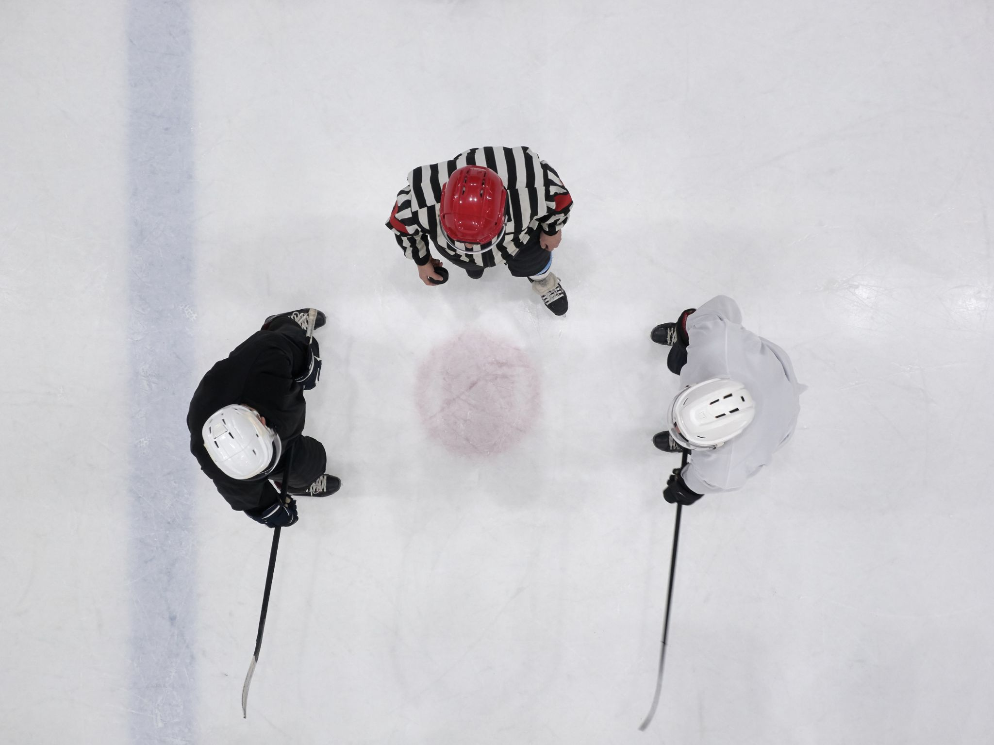 Top view of men playing ice hockey