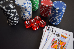 A picture of casino cards, poker chips, and dice.