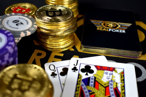 Close up of a bunch of poker chips, Bitcoin coins, and face cards on a table