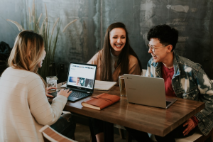 Three people working and laughing together