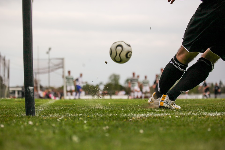 Mid-action shot of a footballer kicking a football