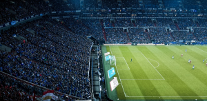 Fans watching an ongoing football match at the stadium