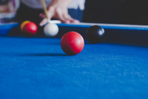 A player hitting a billiard
