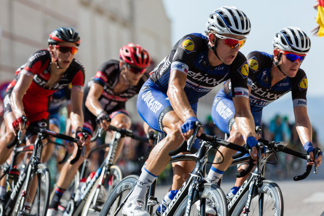 Four professional cyclists in action during a cycling tour