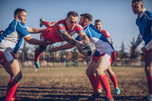 The opposing team trying to stop the winning team’s player from scoring a goal