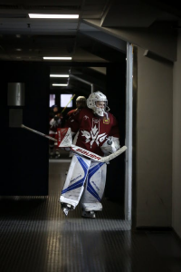 An ice hockey player about to go to the rink