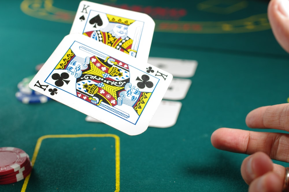 A person throwing cards for casino games