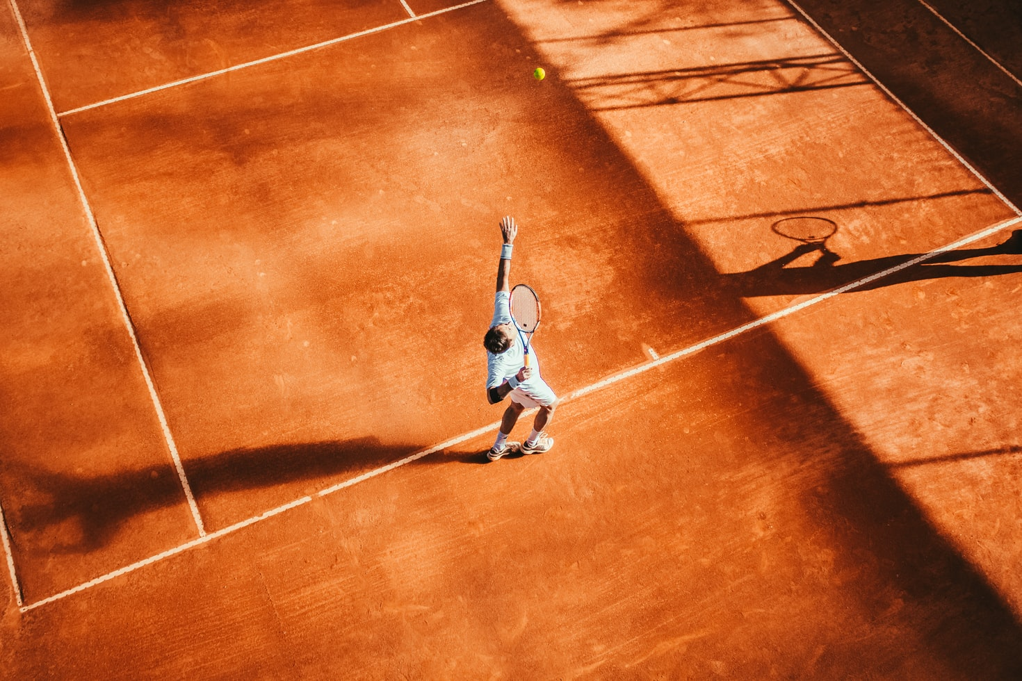 A person serving in a tennis match