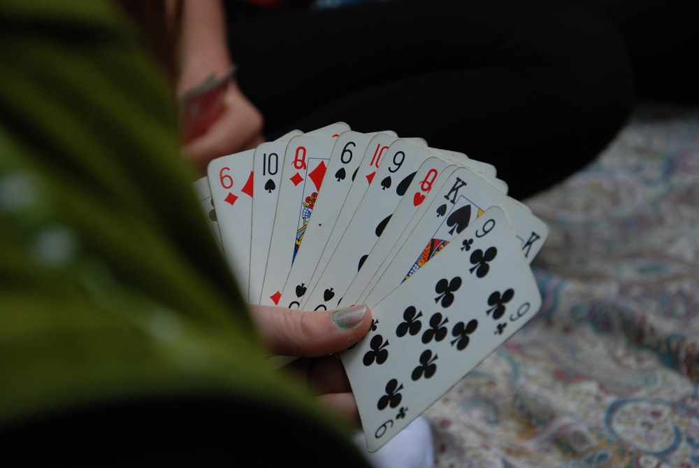 A person holding a stack of cards