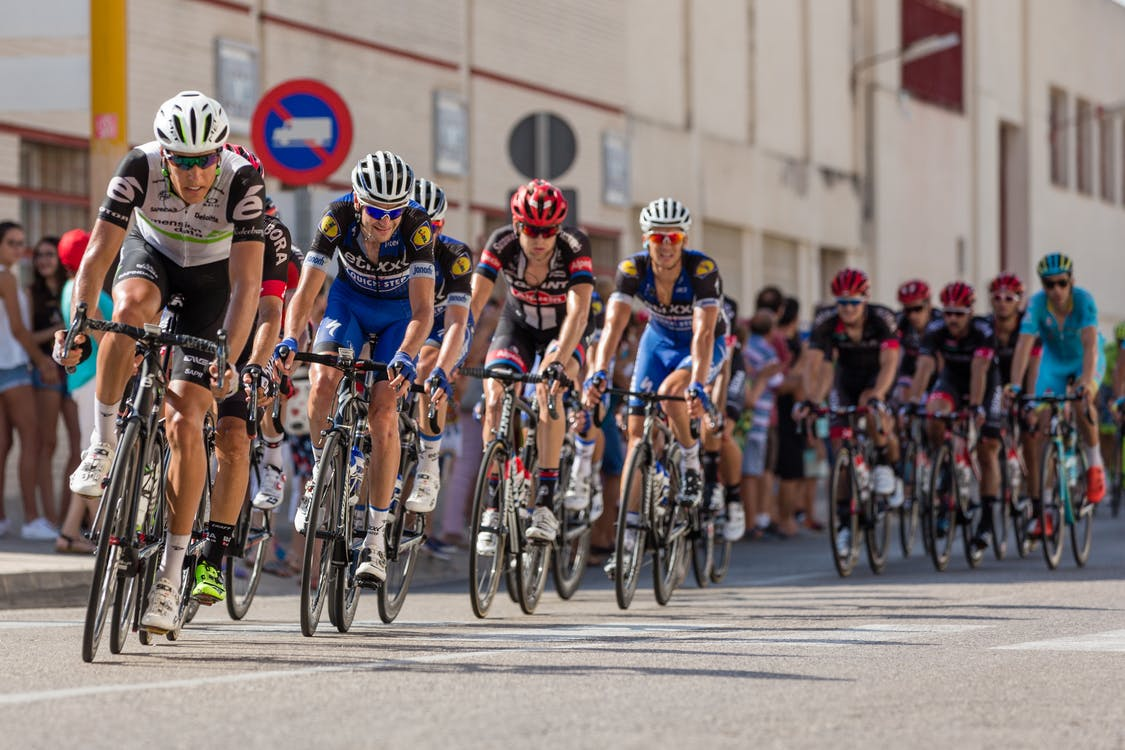A large group of cyclists on the road during a tournament