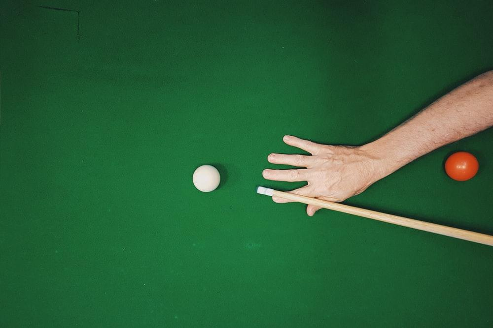 A man ready to pick a shot on a snooker table