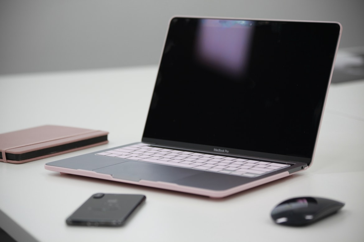 A pink laptop with accessories
