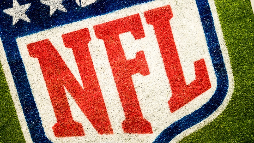 An NFL logo painted on the grass.