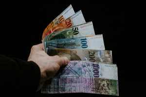 Person holding cash won via abetting site in the UK