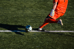 A goalkeeper kicking the ball back into the game