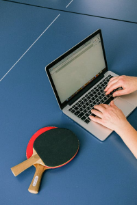 table tennis paddles next to a laptop