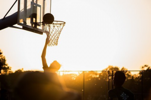 Players playing football during sunset