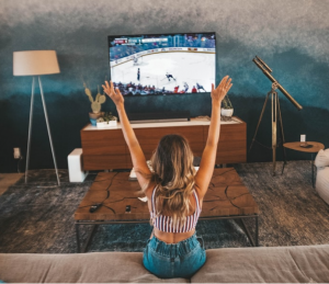 Woman watching a match on tv for sports betting