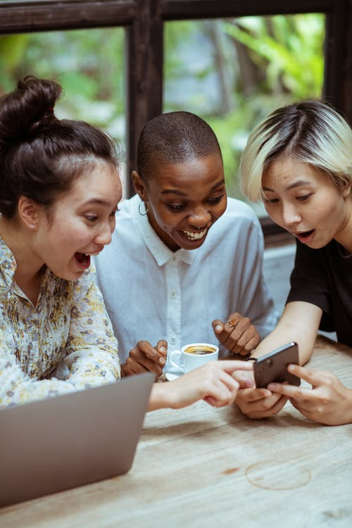 Women laughing while looking at the phone