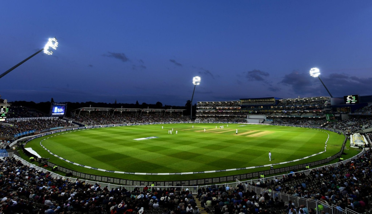 A cricket ground lit up at night.