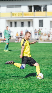 an athlete kicking a football