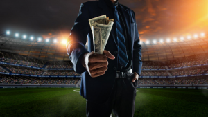 A man holding dollar bills after getting rich from football betting