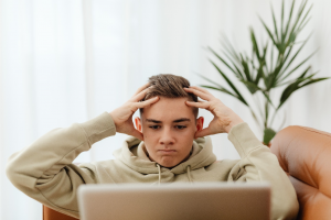 a man holding his head feeling angry