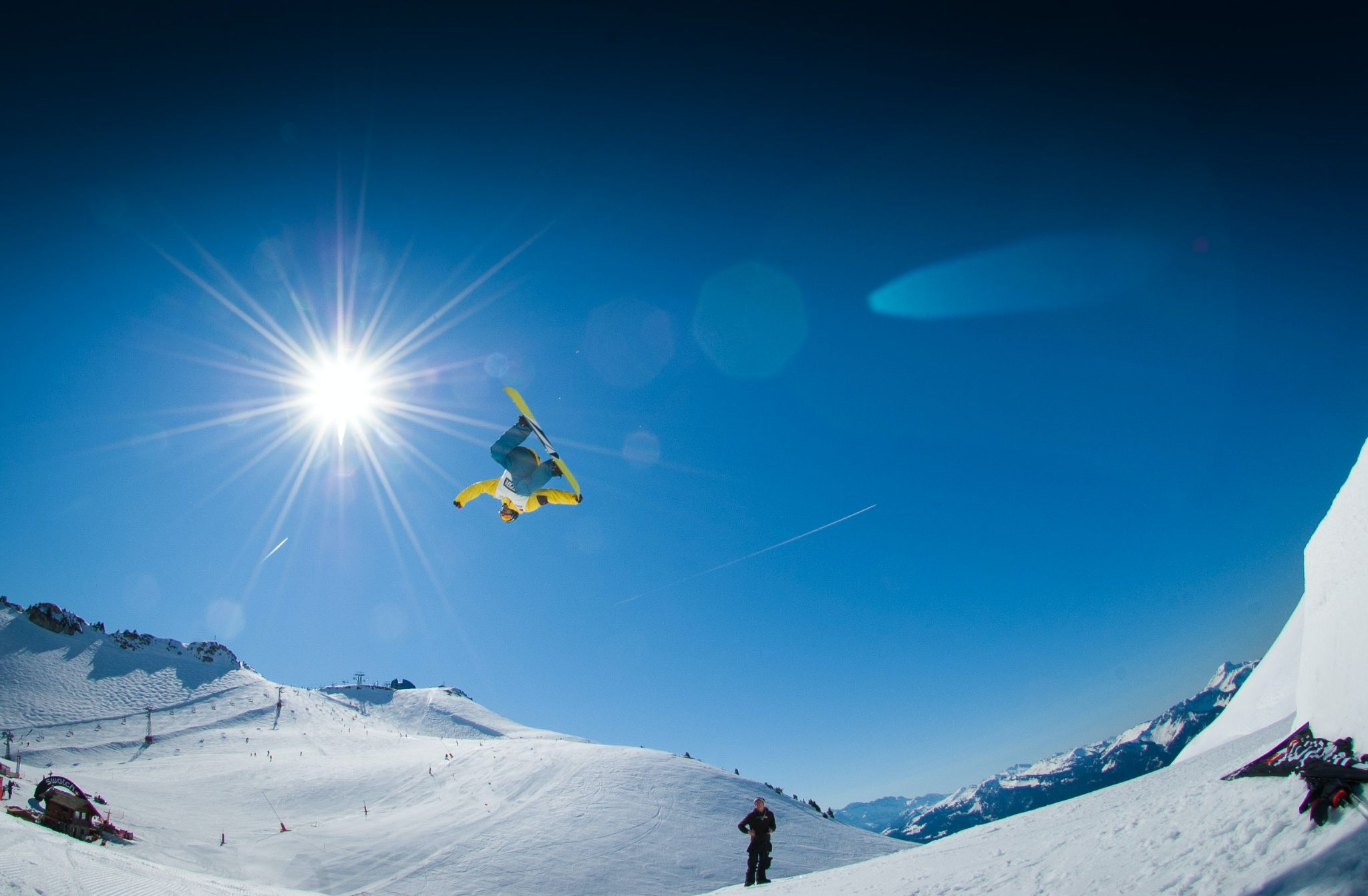 A snowboarder performing stunts in air