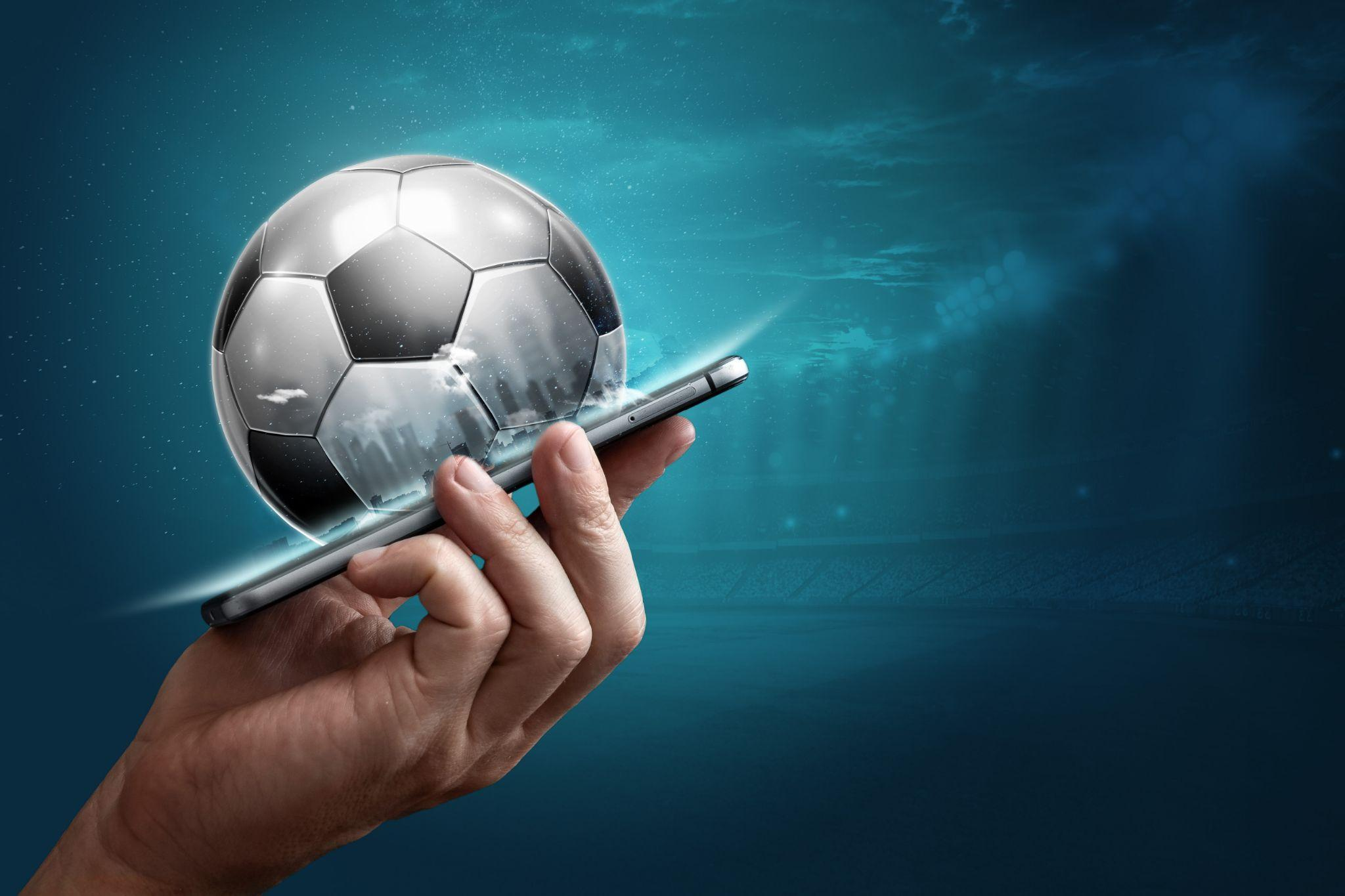 A smartphone with a 3d football on it