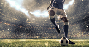 a soccer player kicking the ball in a stadium