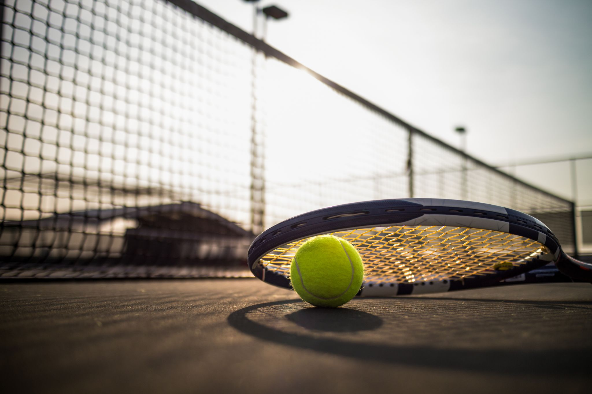 Tennis ball and racket on a court