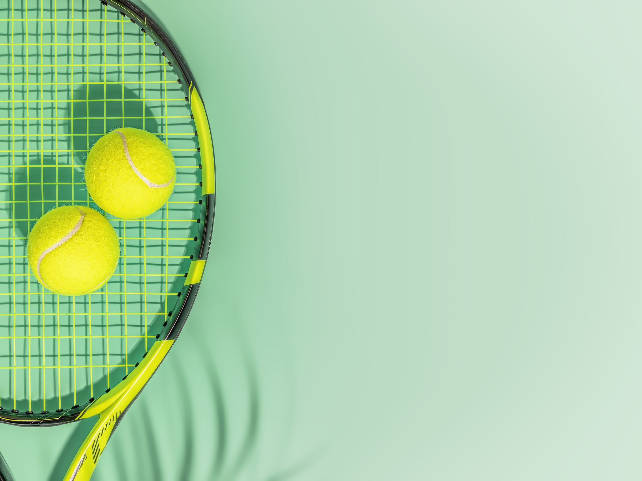 Tennis racket and yellow tennis balls