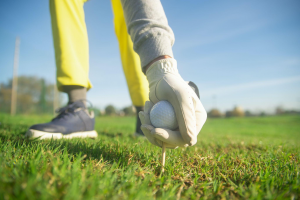 A person playing golf in a field