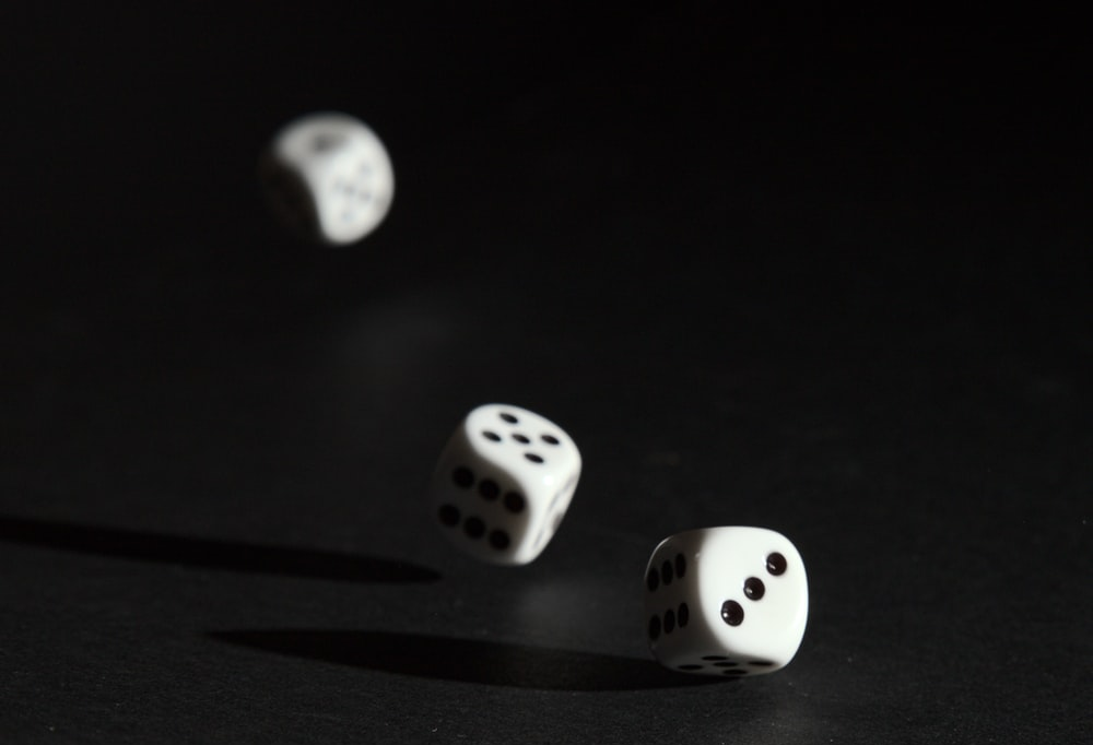 3 dice rolling on the table