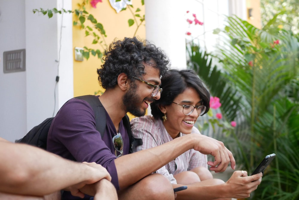 Two people using a phone