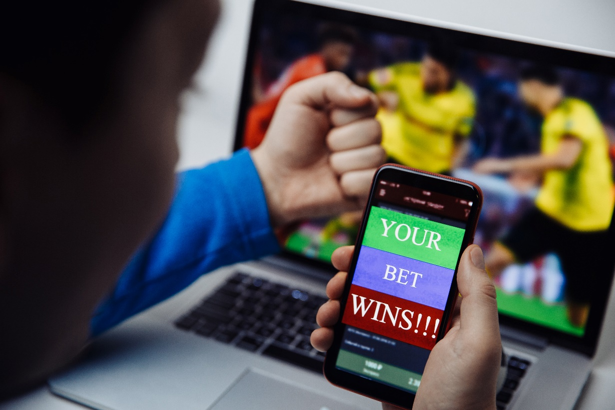 a man using his phone to bet