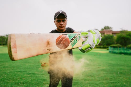 Player hitting the ball with the bat