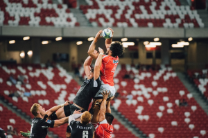 Rugby players tackling and lifting other players during a game