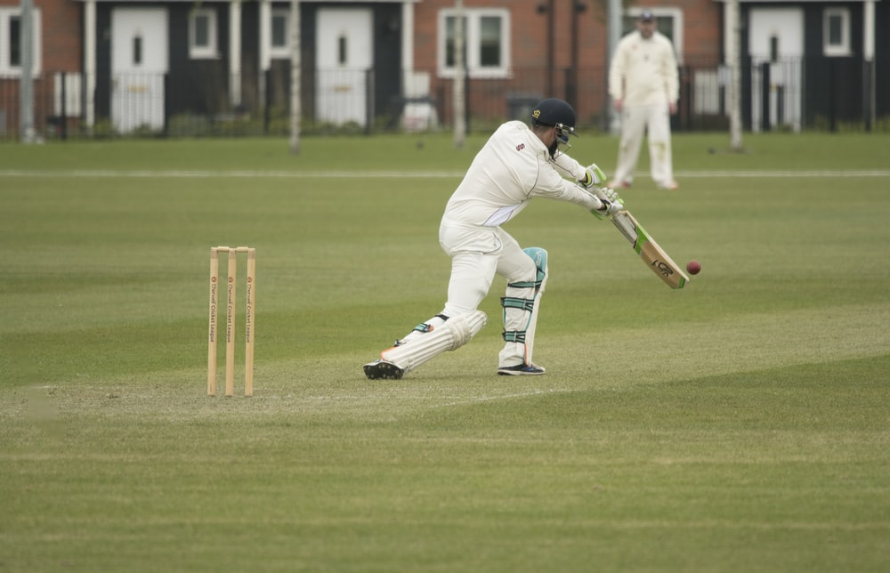 A batsman hitting a ball during a test cricket match