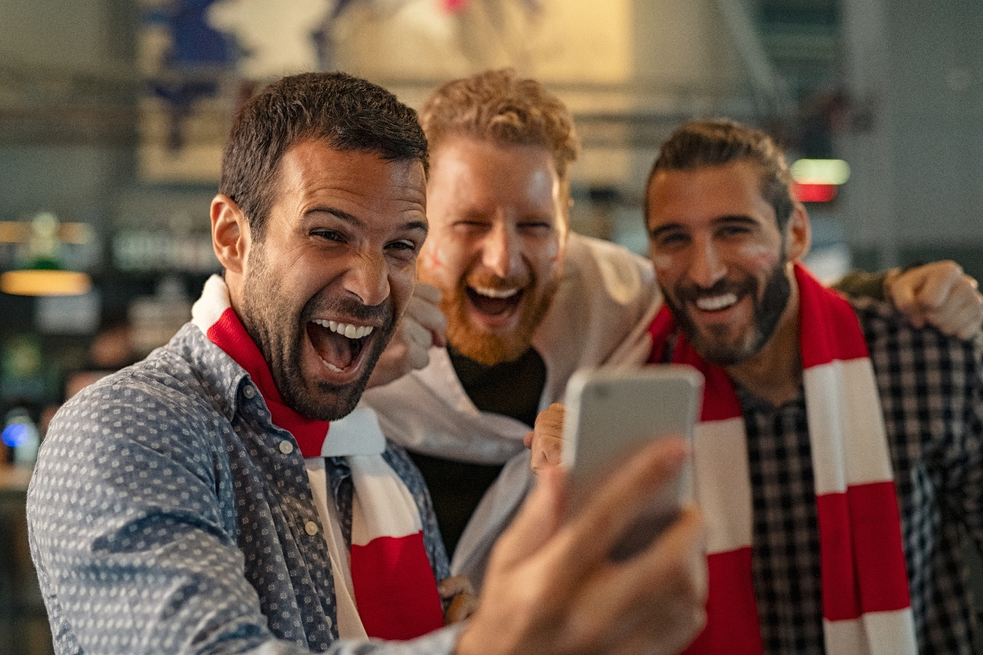 Three friends excited about winning sports bets