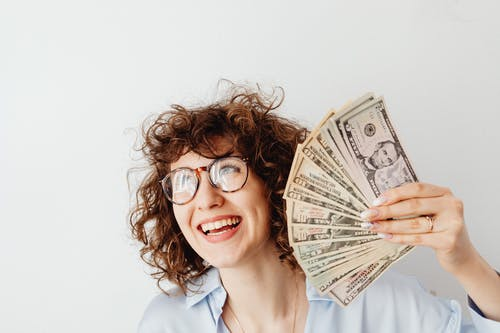 Happy woman holding money