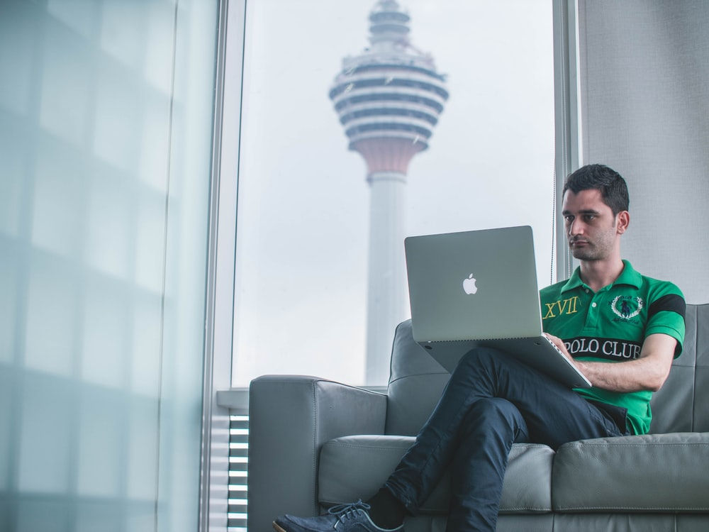 Person watching a cricket match on the laptop